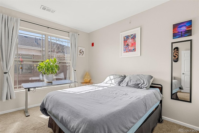 bedroom with light colored carpet, baseboards, and visible vents