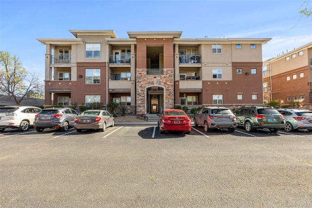 view of building exterior featuring uncovered parking