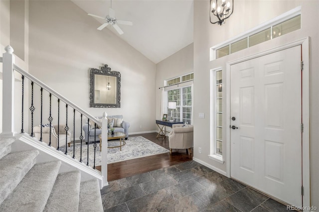 5168 Rocky Mountain Dr, Castle Rock, CO 80109 - foyer entrance with high vaulted ceiling, stairway, dark stone finish floors, and ceiling fan