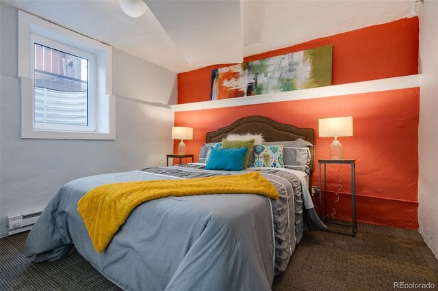 bedroom featuring carpet flooring and a baseboard heating unit