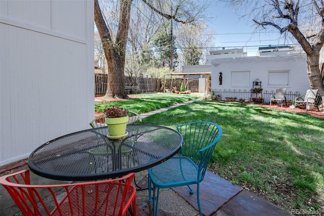 view of yard with outdoor dining space and a patio