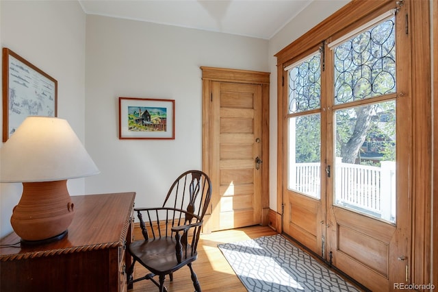 office space with light wood finished floors, baseboards, crown molding, and french doors