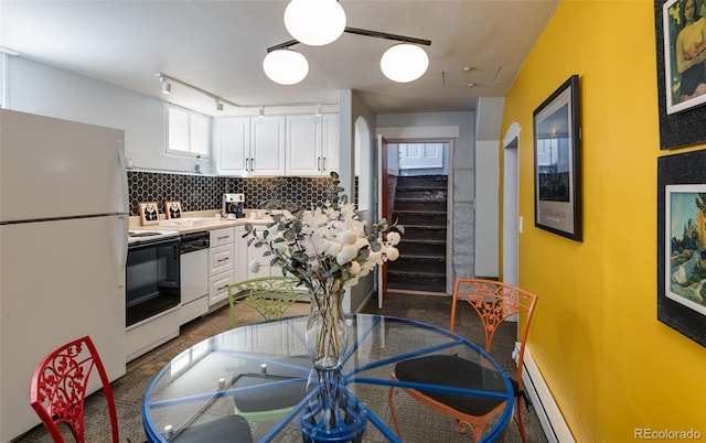 kitchen featuring white appliances, white cabinets, tasteful backsplash, and light countertops