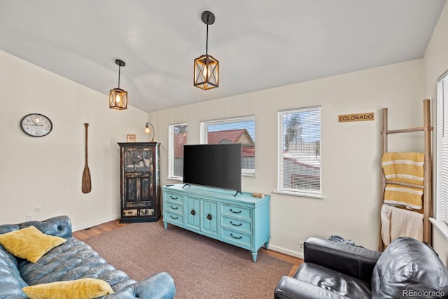 living room with wood finished floors, vaulted ceiling, and baseboards