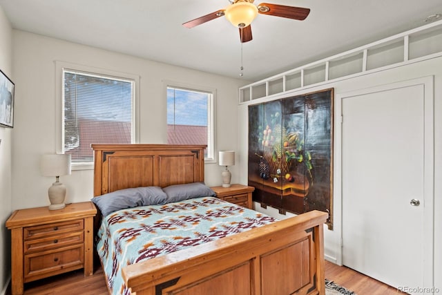 bedroom with light wood-type flooring and ceiling fan