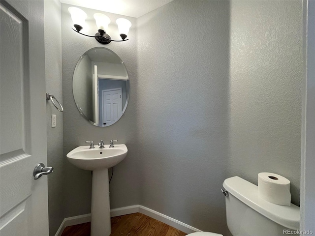 bathroom featuring hardwood / wood-style floors and toilet