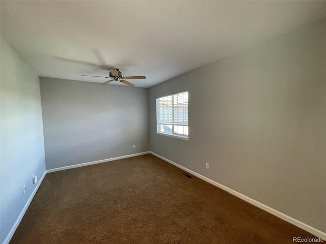 carpeted spare room with ceiling fan