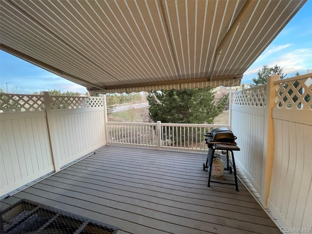 wooden terrace with a grill