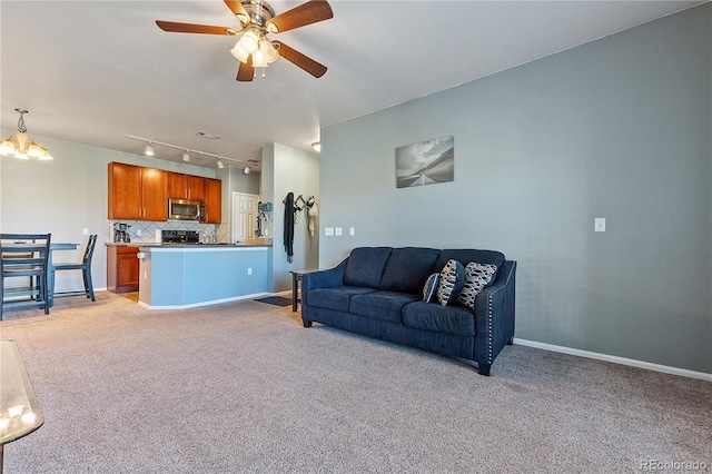 2682 S Cathay Way Unit 307, Aurora, CO 80013 - living area with light colored carpet, ceiling fan, rail lighting, and a chandelier
