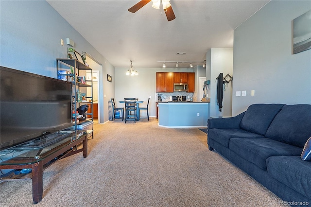 2682 S Cathay Way Unit 307, Aurora, CO 80013 - living room with light colored carpet, a ceiling fan, a chandelier, and track lighting