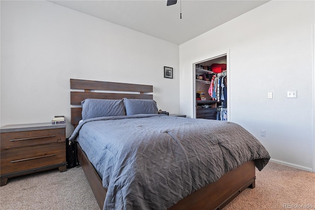 2682 S Cathay Way Unit 307, Aurora, CO 80013 - bedroom featuring light carpet, a walk in closet, baseboards, a closet, and ceiling fan