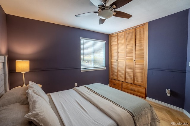 bedroom with ceiling fan and a closet