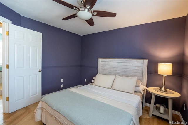 bedroom with ceiling fan and light hardwood / wood-style flooring