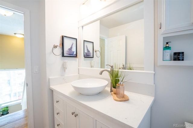 bathroom with vanity and wood-type flooring