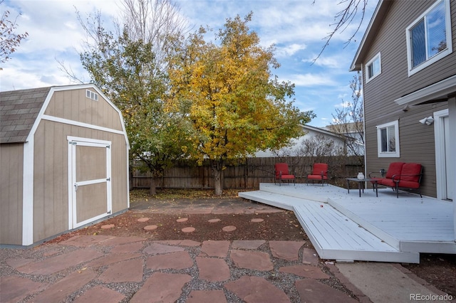 view of patio / terrace featuring a storage unit and a wooden deck