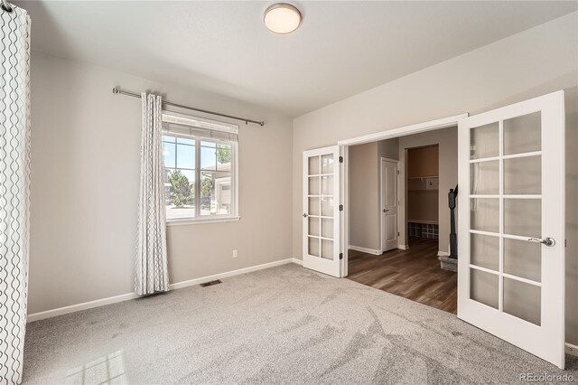 6612 S Muscadine Ct, Aurora, CO 80016 - unfurnished bedroom featuring french doors, carpet, and baseboards