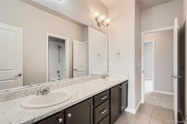 6612 S Muscadine Ct, Aurora, CO 80016 - full bathroom with double vanity, tile patterned flooring, baseboards, and shower / tub combination