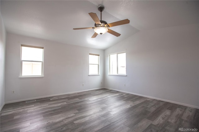 empty room featuring dark wood-type flooring, ceiling fan, and vaulted ceiling