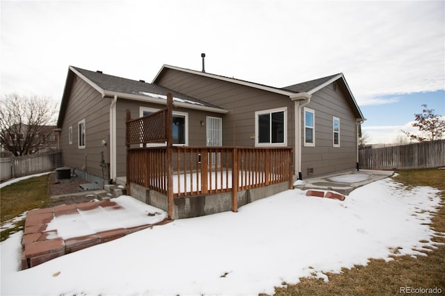 snow covered property with a deck