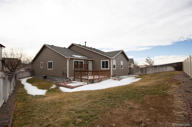 back of house with a yard, a deck, and central air condition unit