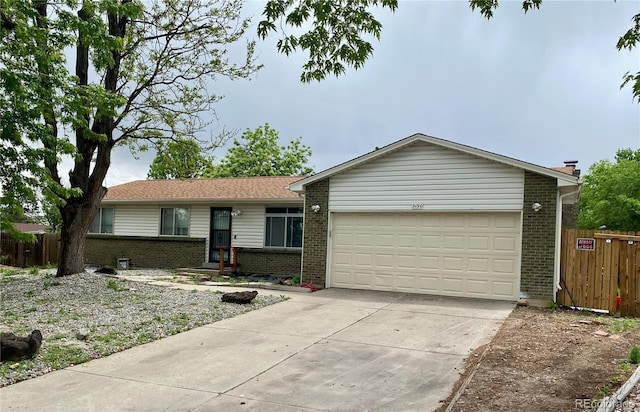 3190 S Joplin Ct, Aurora, CO 80013 - ranch-style home featuring brick siding, driveway, an attached garage, and fence