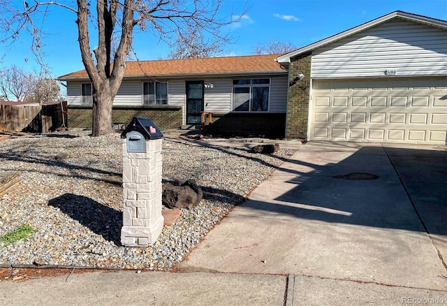 3190 S Joplin Ct, Aurora, CO 80013 - ranch-style house featuring brick siding, an attached garage, driveway, and fence