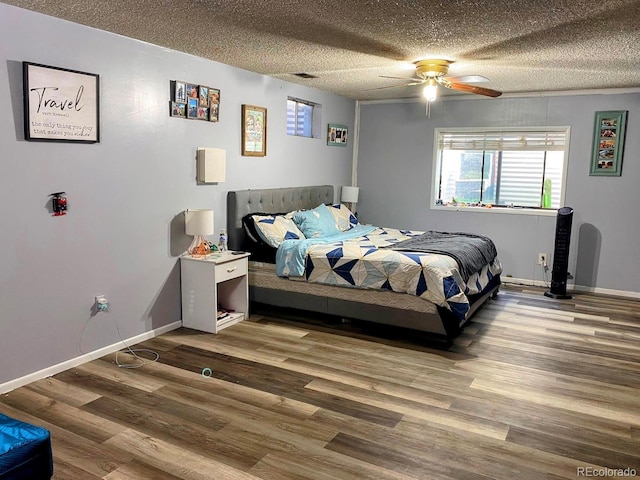 3190 S Joplin Ct, Aurora, CO 80013 - bedroom with wood finished floors, a textured ceiling, baseboards, and a ceiling fan