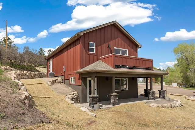 826 Meadow Ln, Palmer Lake, CO 80133 - rear view of property with a balcony, board and batten siding, and a shingled roof