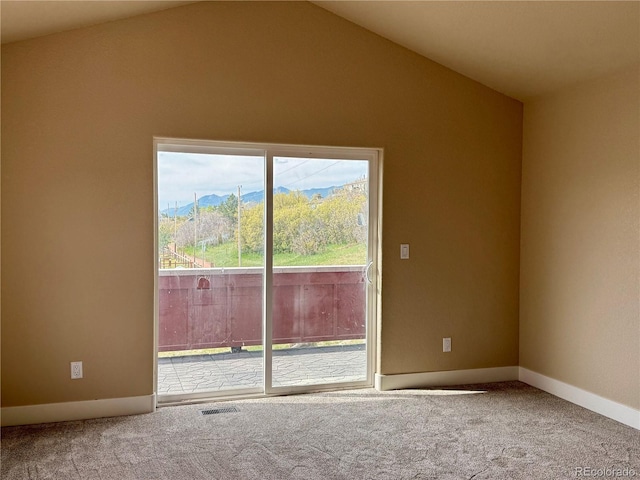 826 Meadow Ln, Palmer Lake, CO 80133 - carpeted empty room with lofted ceiling, a mountain view, and baseboards