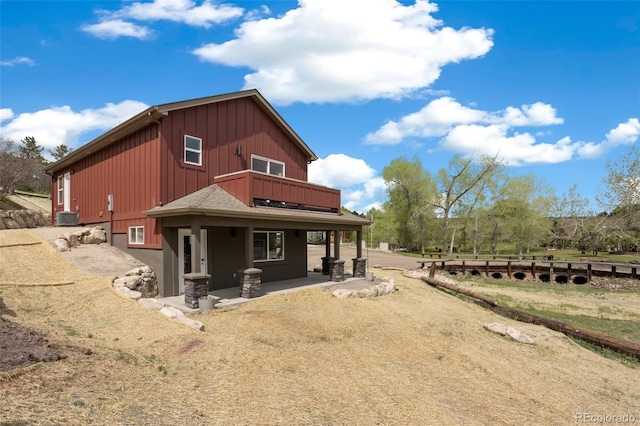 826 Meadow Ln, Palmer Lake, CO 80133 - back of house featuring board and batten siding and a balcony