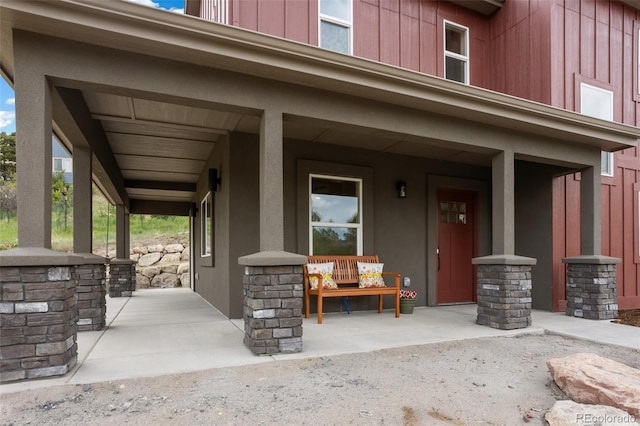 826 Meadow Ln, Palmer Lake, CO 80133 - doorway to property with covered porch and board and batten siding