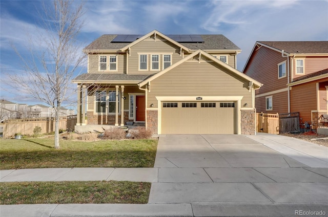 craftsman inspired home with a front lawn, a garage, and solar panels