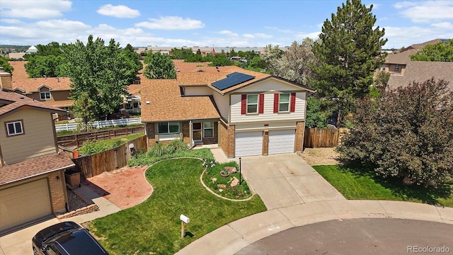 11149 Seton Pl, Westminster, CO 80031 - view of front facade featuring roof mounted solar panels, concrete driveway, an attached garage, and brick siding