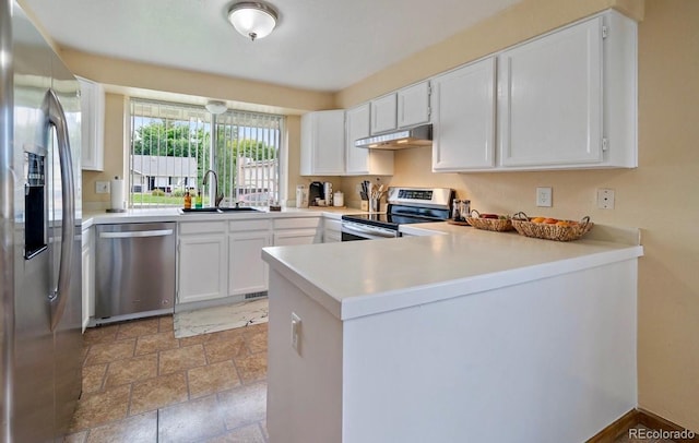 11149 Seton Pl, Westminster, CO 80031 - kitchen featuring appliances with stainless steel finishes, under cabinet range hood, a peninsula, white cabinetry, and light countertops