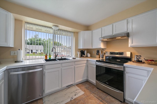 11149 Seton Pl, Westminster, CO 80031 - kitchen with appliances with stainless steel finishes, under cabinet range hood, white cabinetry, and light countertops
