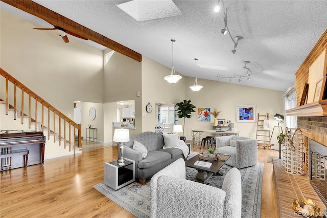 11149 Seton Pl, Westminster, CO 80031 - living area featuring stairs, light wood-type flooring, rail lighting, beamed ceiling, and a skylight