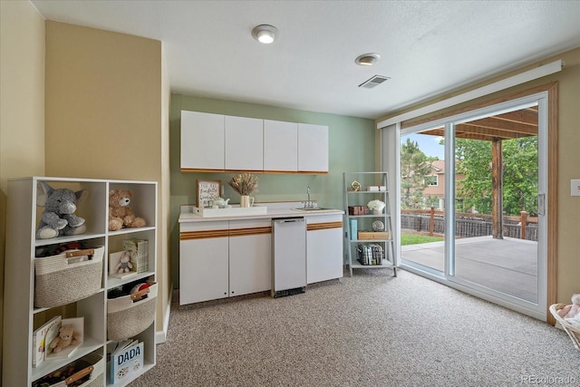 11149 Seton Pl, Westminster, CO 80031 - kitchen with light colored carpet, white cabinets, and light countertops