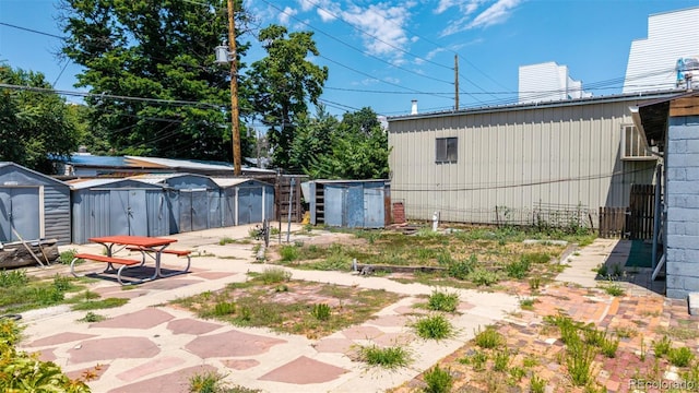3907 Inca St Unit 3905, Denver, CO 80211 - view of yard featuring a storage unit and a patio area
