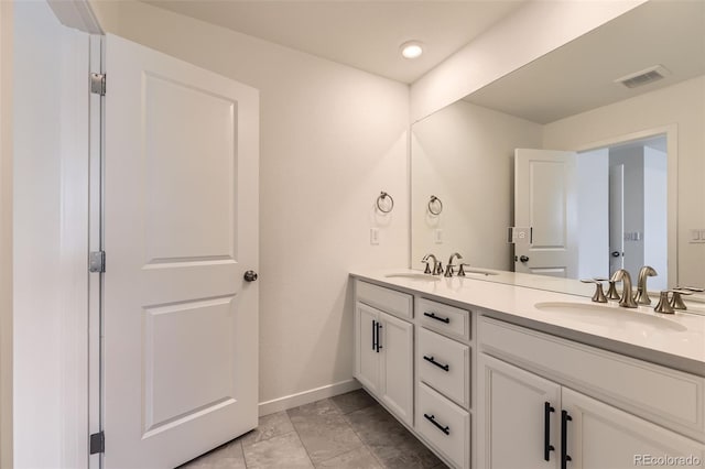 8982 Spaulding St, Parker, CO 80134 - bathroom featuring baseboards, double vanity, and recessed lighting