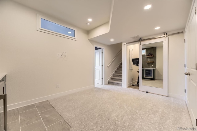 8982 Spaulding St, Parker, CO 80134 - basement featuring a barn door, recessed lighting, stairs, and baseboards