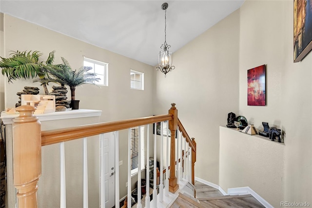 stairway featuring a chandelier