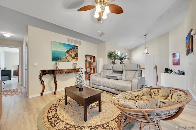 living room featuring ceiling fan, light wood-type flooring, and vaulted ceiling