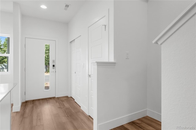 foyer entrance with light hardwood / wood-style floors