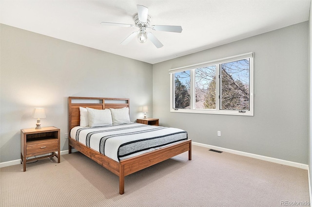 bedroom with light colored carpet, baseboards, visible vents, and ceiling fan