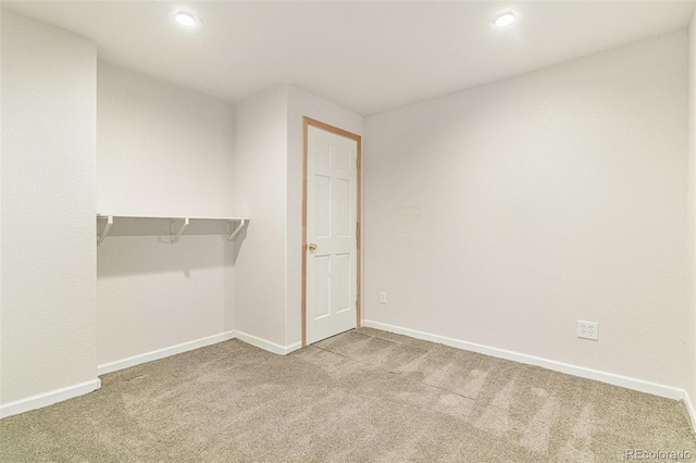 unfurnished bedroom featuring recessed lighting, carpet, and baseboards