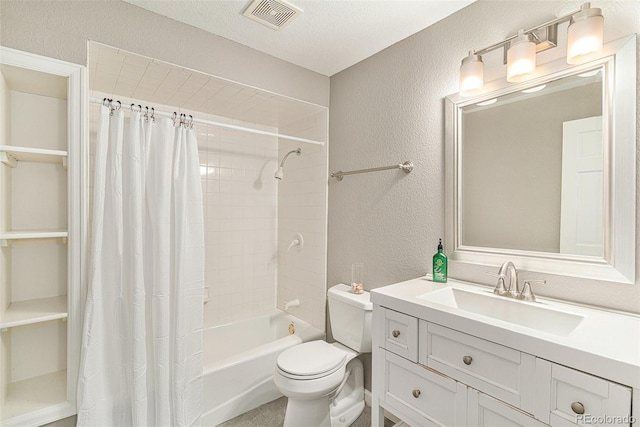 full bathroom with visible vents, toilet, shower / bath combo, a textured wall, and vanity