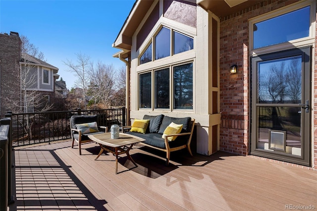 wooden terrace with an outdoor living space