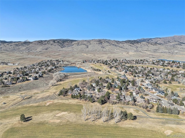 birds eye view of property with a water and mountain view