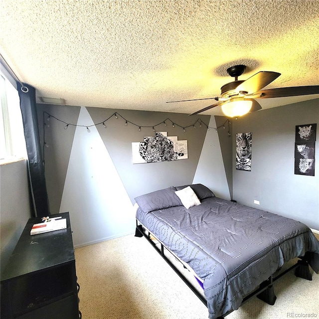 bedroom featuring carpet, ceiling fan, and a textured ceiling