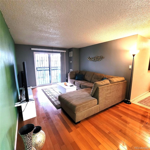 living room featuring hardwood / wood-style floors and a textured ceiling